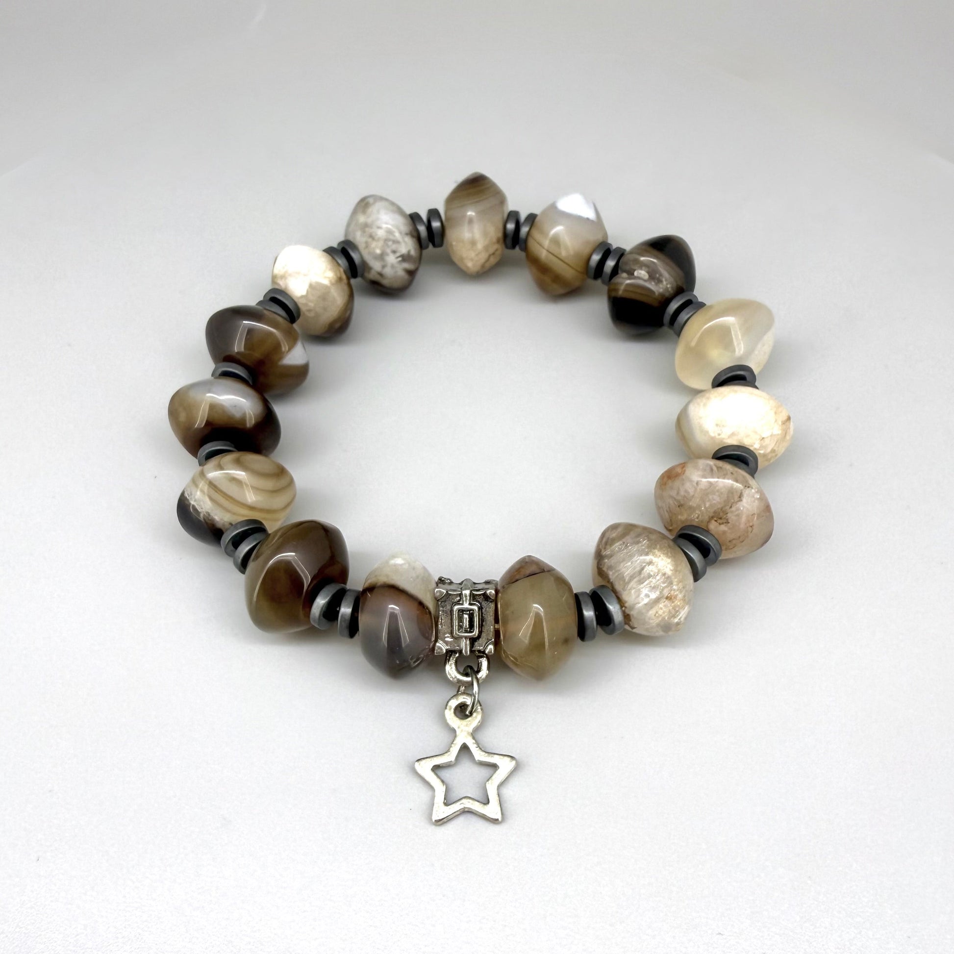 Agate and hematite beaded bracelet, 19cm, beige-brown gemstone beads with metallic hematite accents and silver star charm on elastic stretch band.