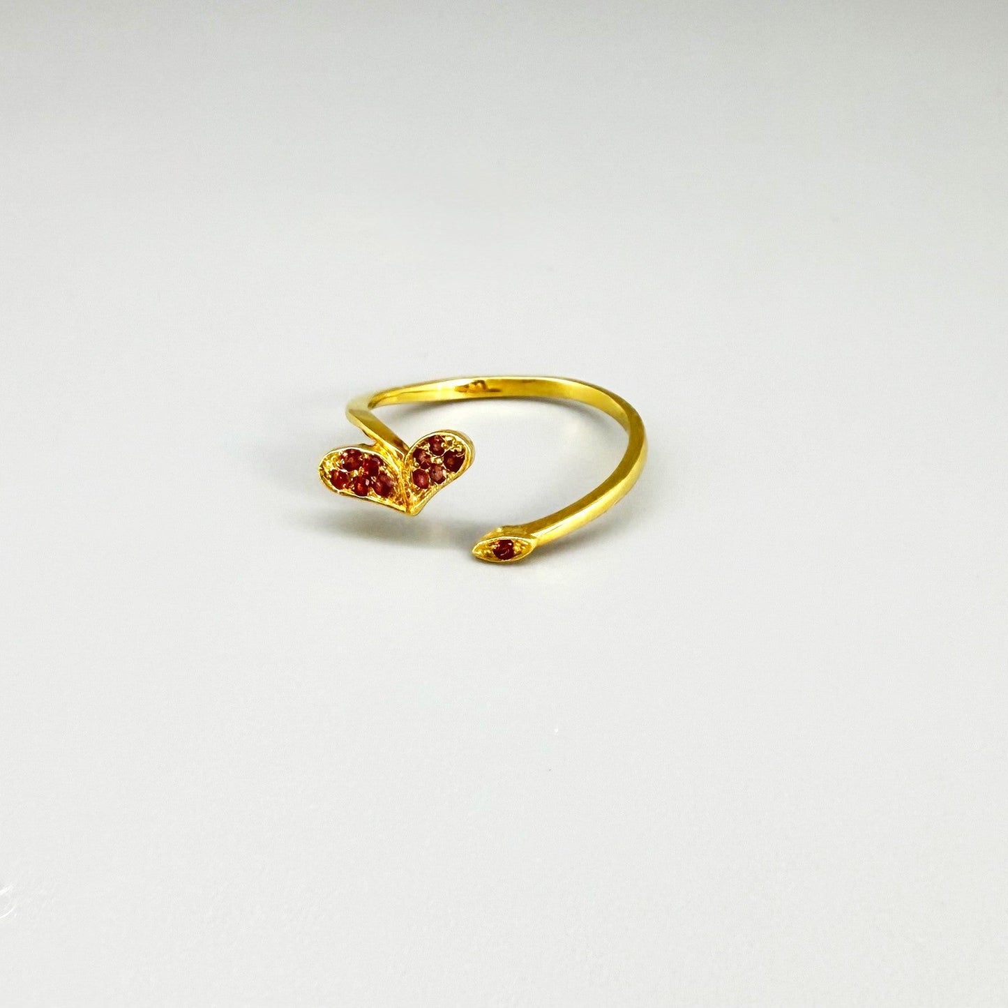 23k gold open ring with 0.11 ct ruby and heart-shaped detail, adjustable size 52–55.