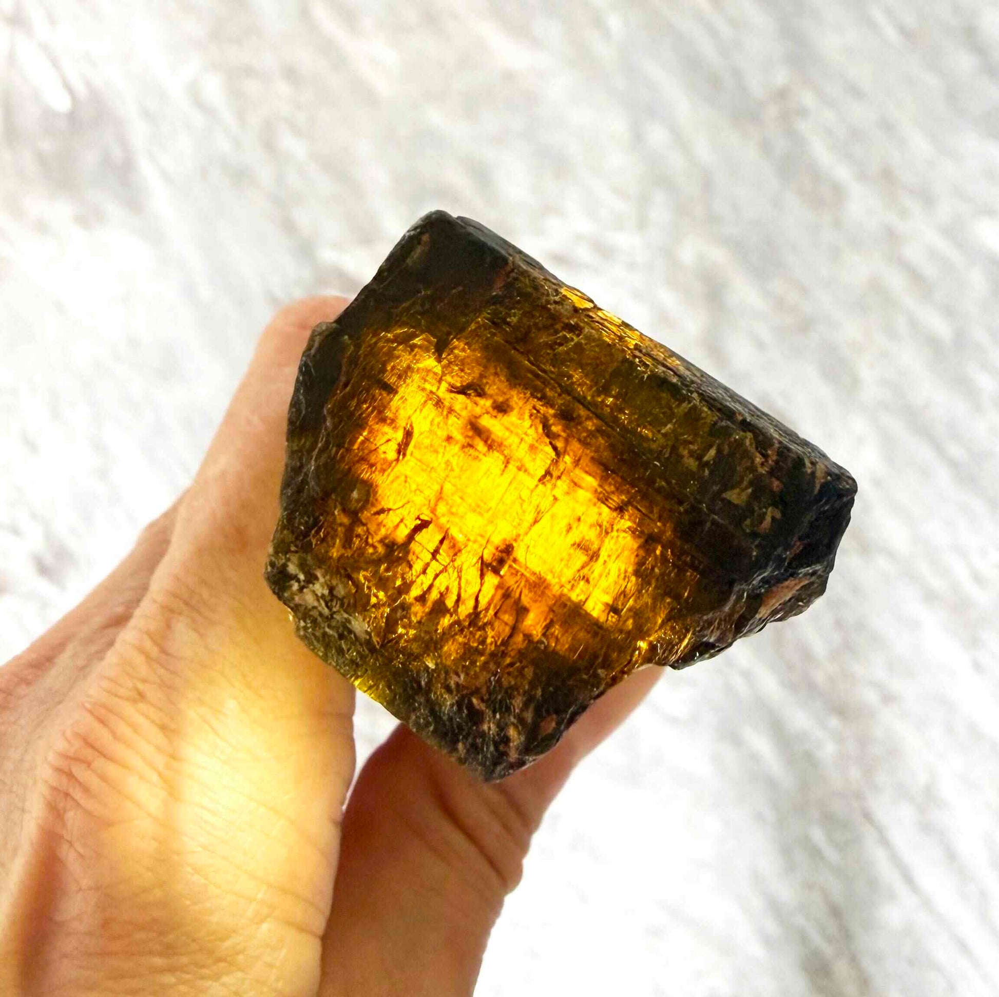 Untreated yellow sapphire rough (corundum) in warm yellow-orange hues, uncut natural gemstone.