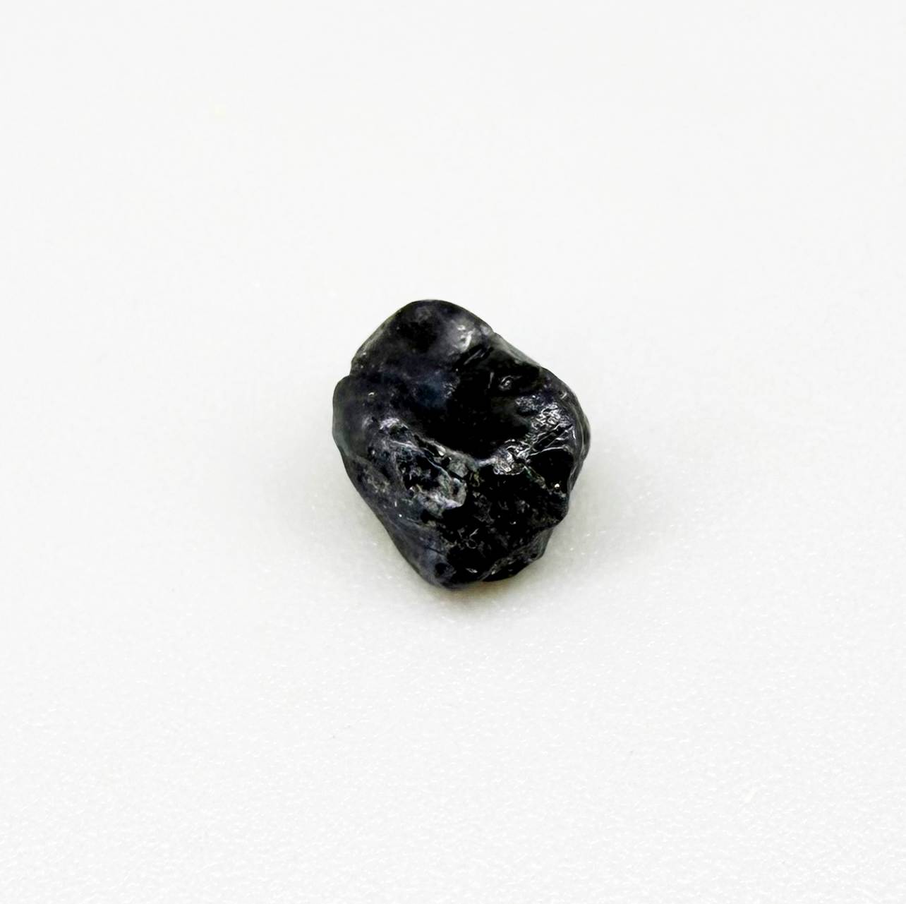 Untreated sky to royal blue sapphire rough, natural uncut corundum photographed on neutral background.