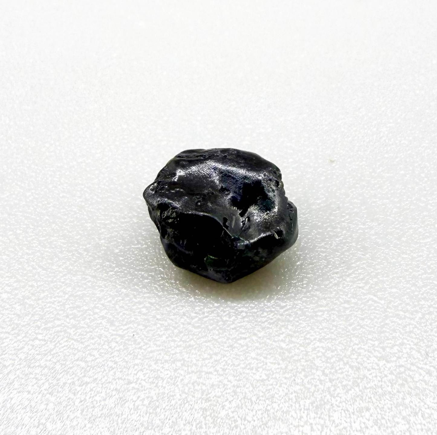 Untreated sky to royal blue sapphire rough, natural uncut corundum photographed on neutral background.