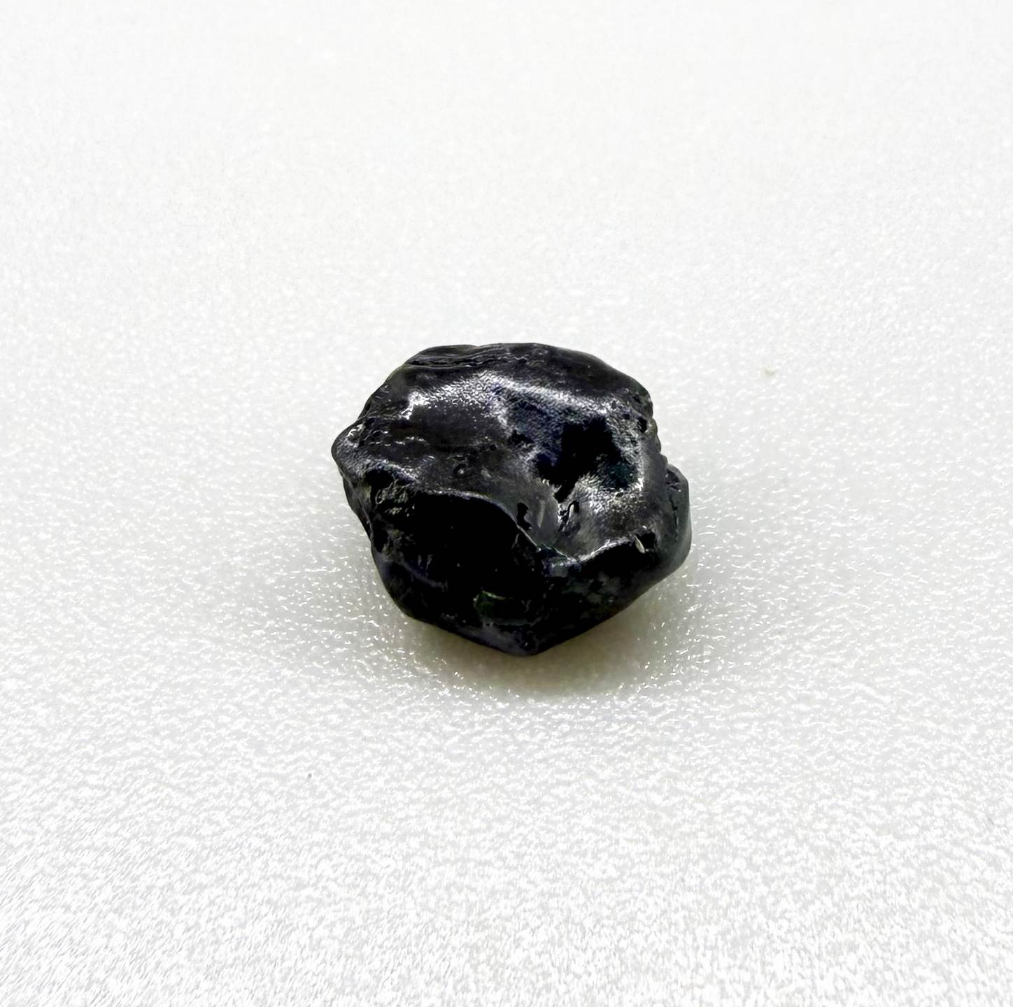 Untreated sky to royal blue sapphire rough, natural uncut corundum photographed on neutral background.
