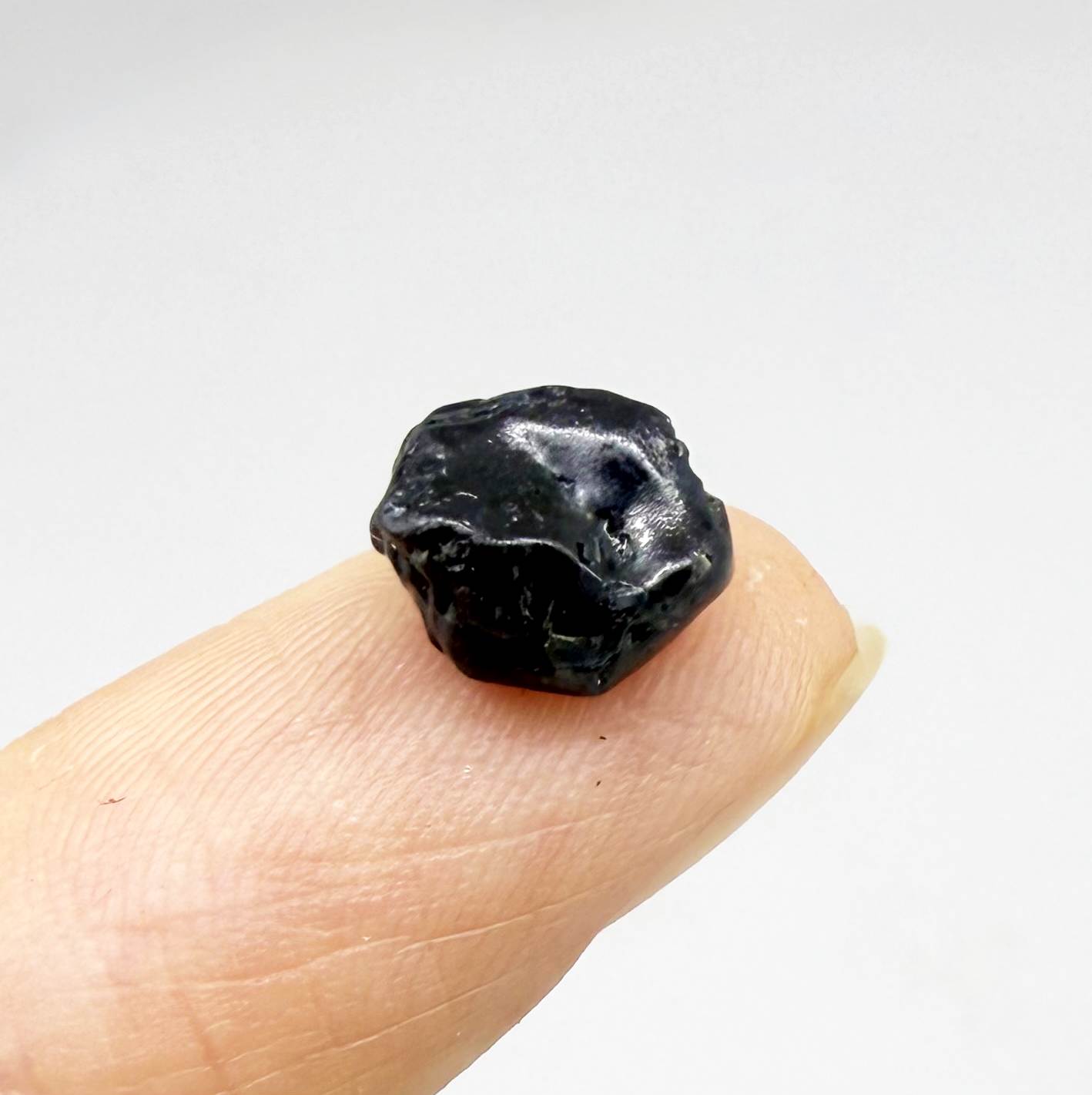 Untreated sky to royal blue sapphire rough, natural uncut corundum photographed on neutral background.