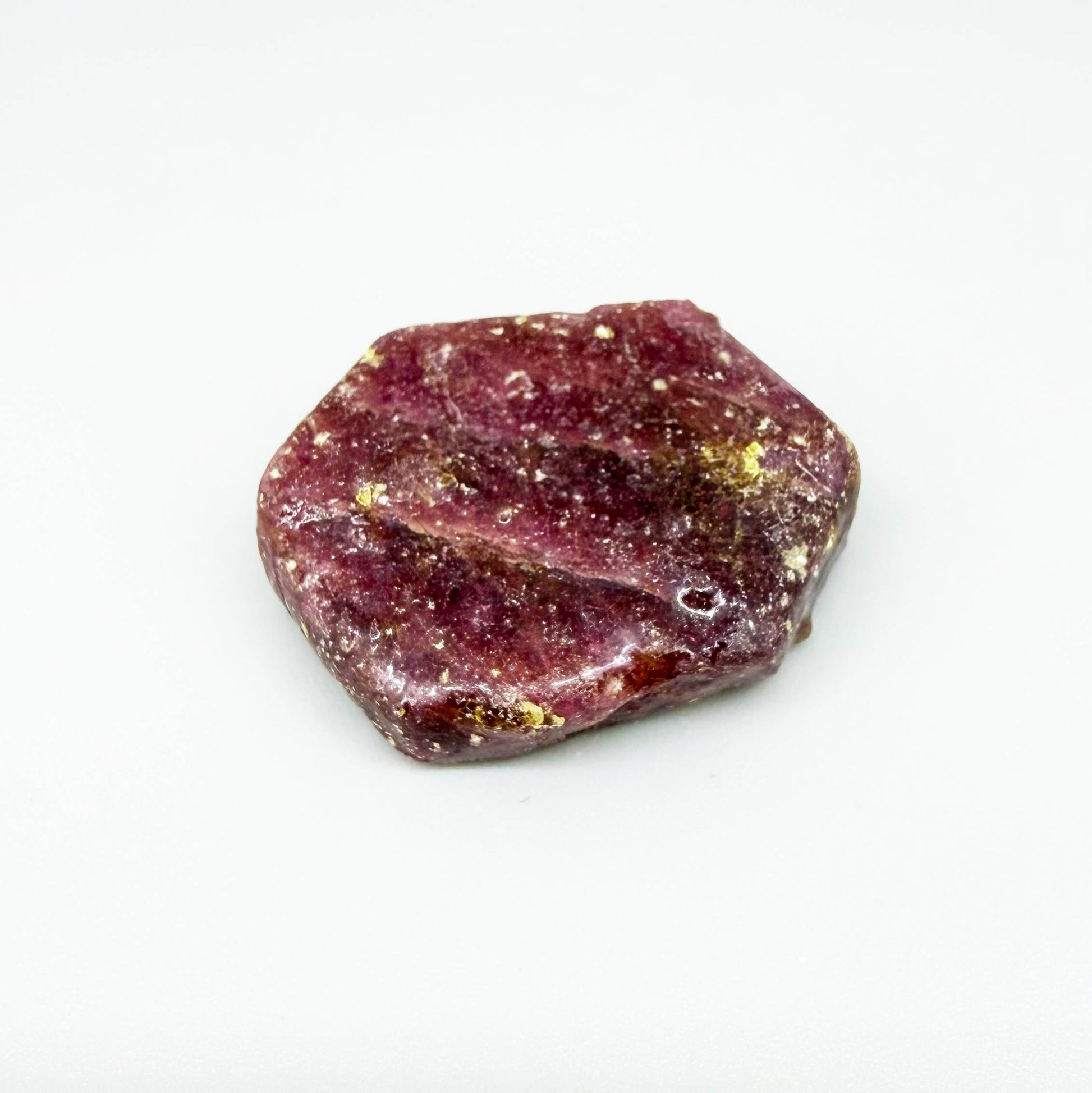 Natural Ruby rough (Corundum) in pink-bordeaux tones, treated gemstone specimen.