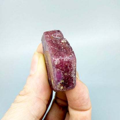 Natural Ruby rough (Corundum) in pink-bordeaux tones, treated gemstone specimen.