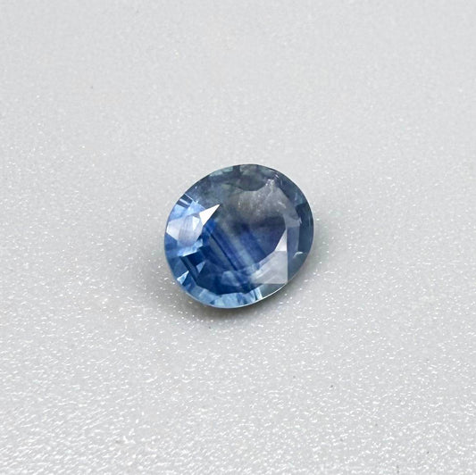 Oval soft medium blue sapphire from Bangkaja, Thailand, unheated, with natural color zoning and soft silky blue tone.