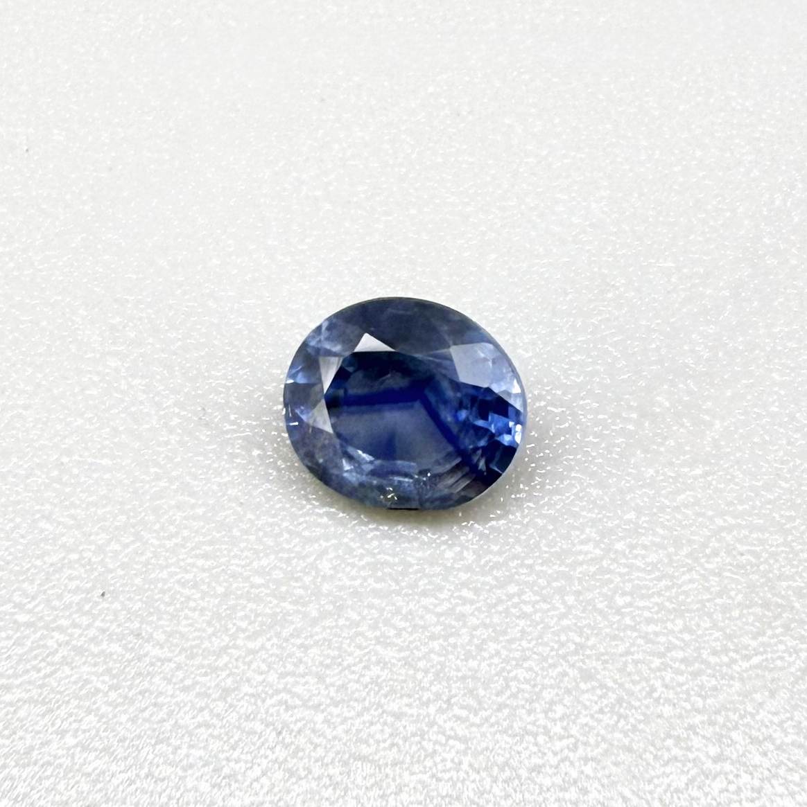 Oval medium steel blue sapphire from Bangkaja, Thailand, unheated, with natural color zoning and lively brilliance.