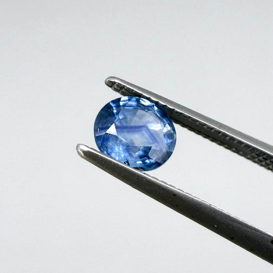 Oval medium steel blue sapphire from Bangkaja, Thailand, unheated, with natural color zoning and lively brilliance.