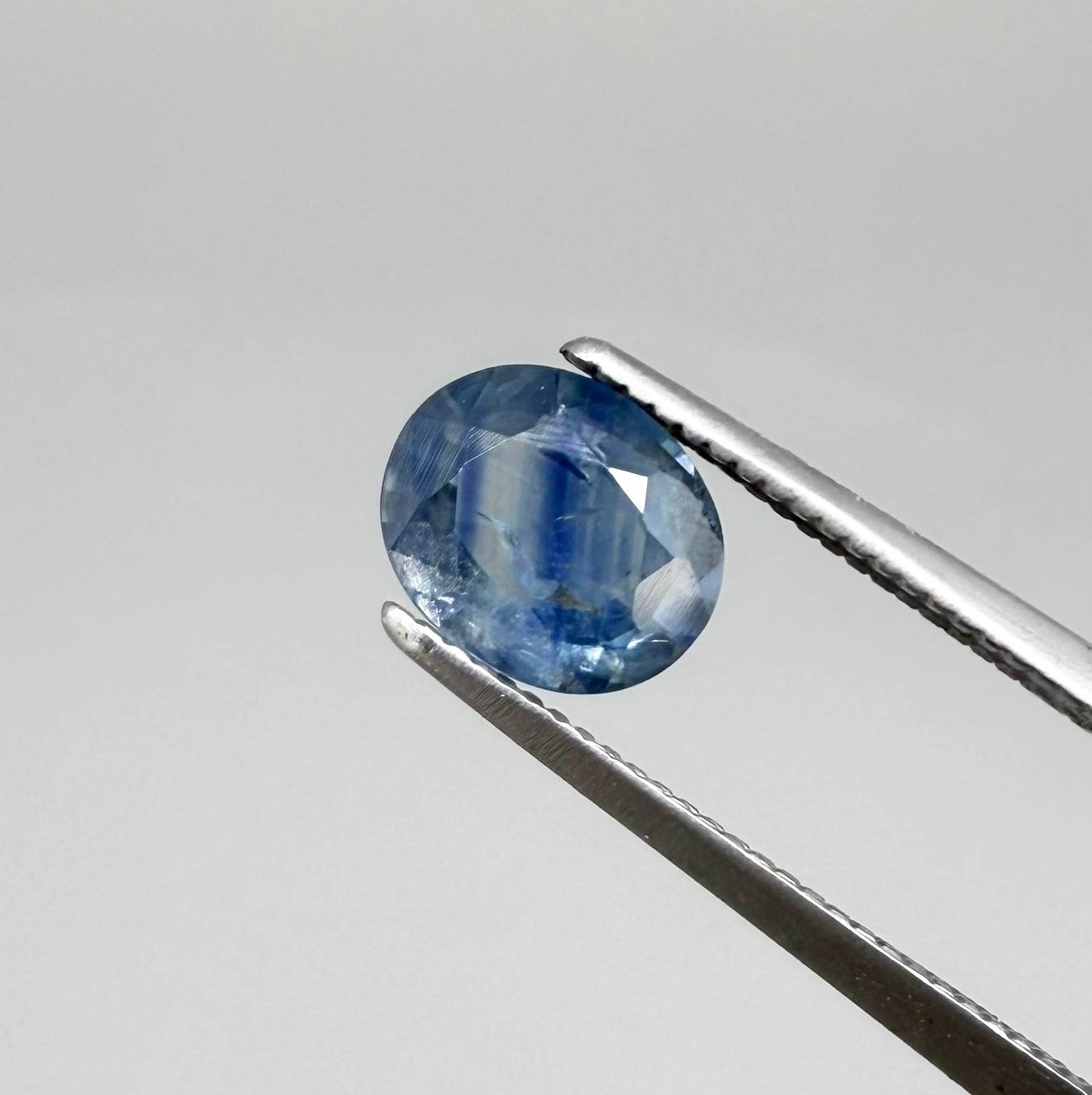 Round light medium blue sapphire from Sri Lanka with natural color zoning and lively brilliance.