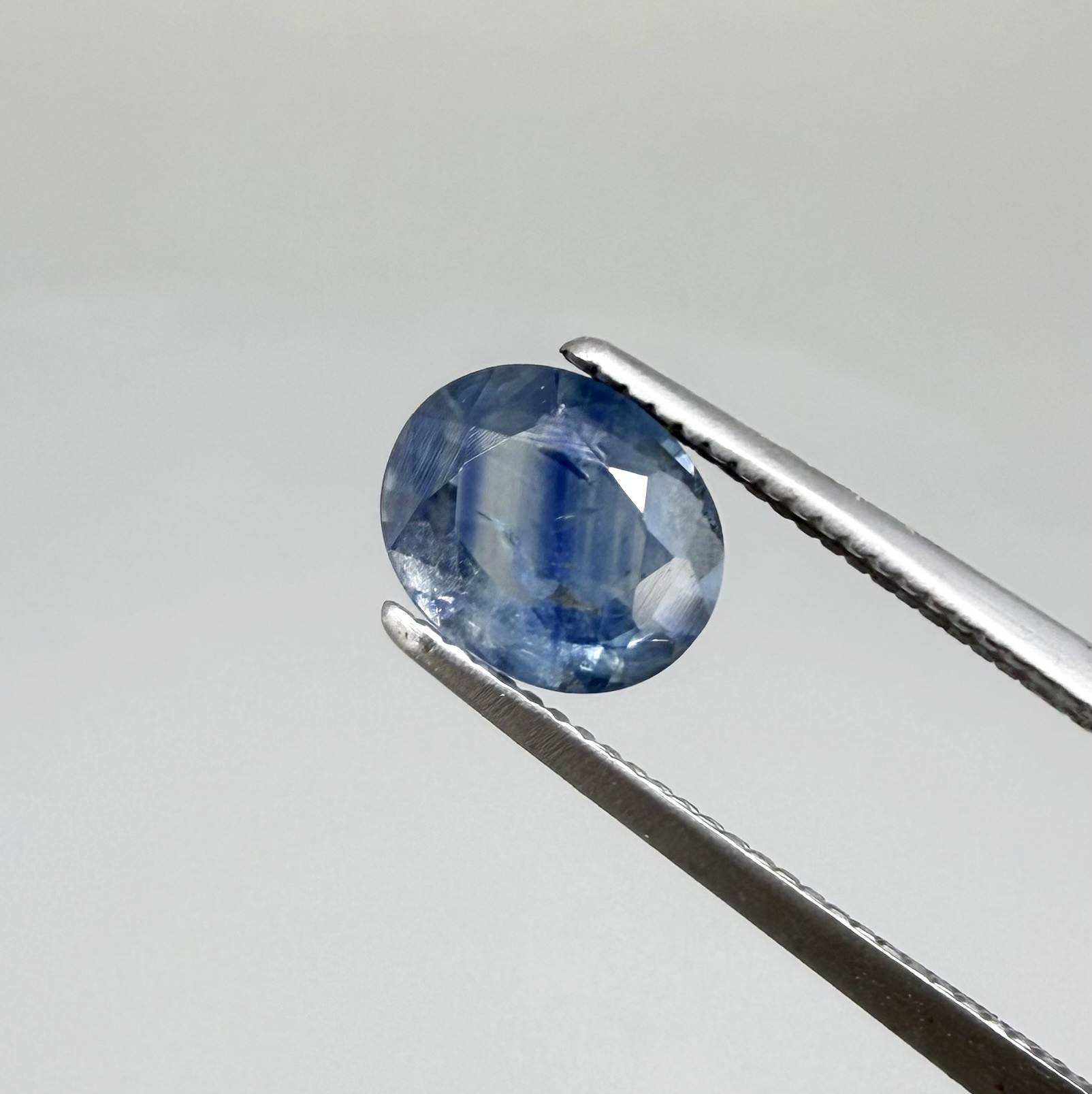 Round light medium blue sapphire from Sri Lanka with natural color zoning and lively brilliance.