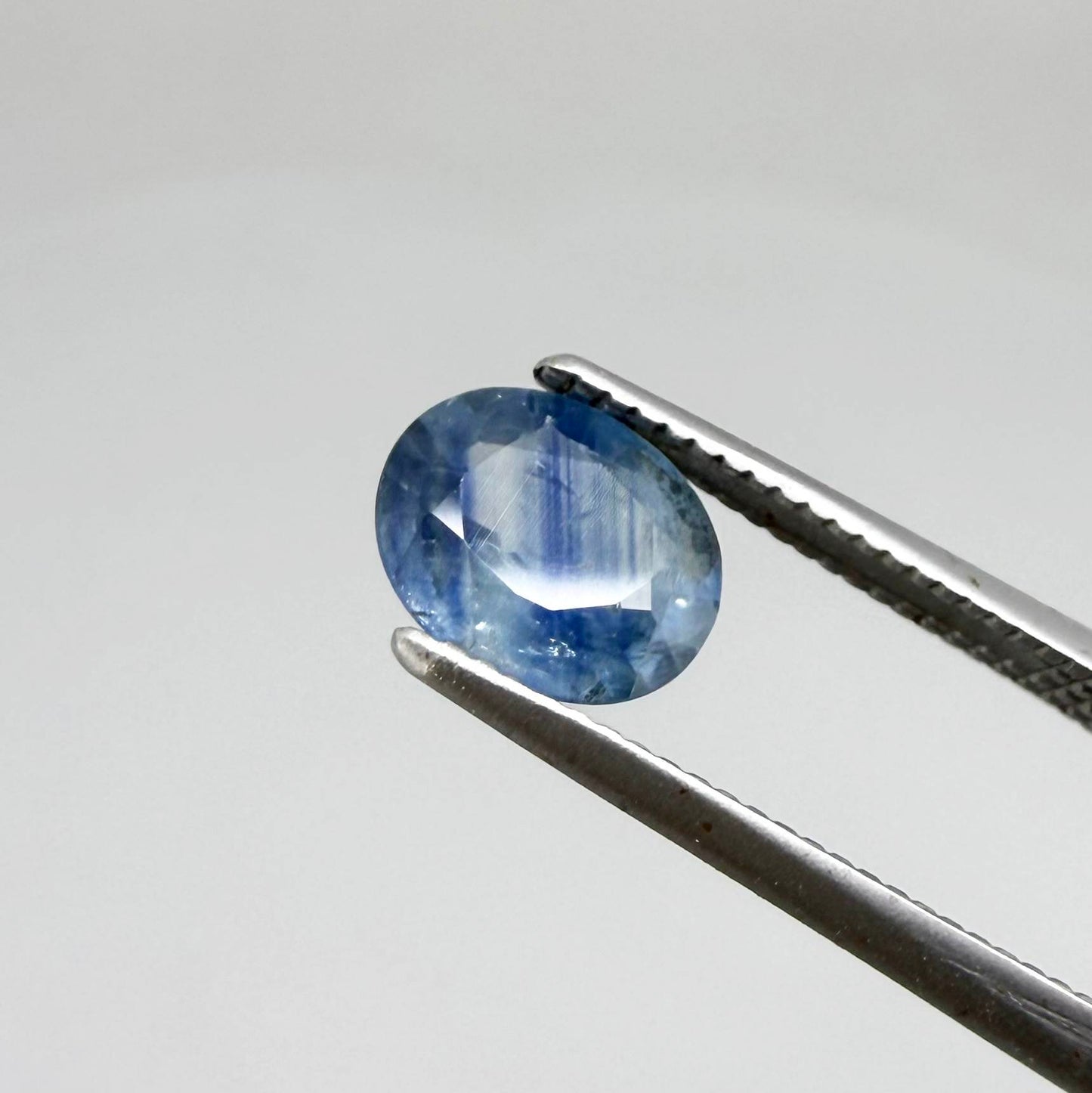Round light medium blue sapphire from Sri Lanka with natural color zoning and lively brilliance.