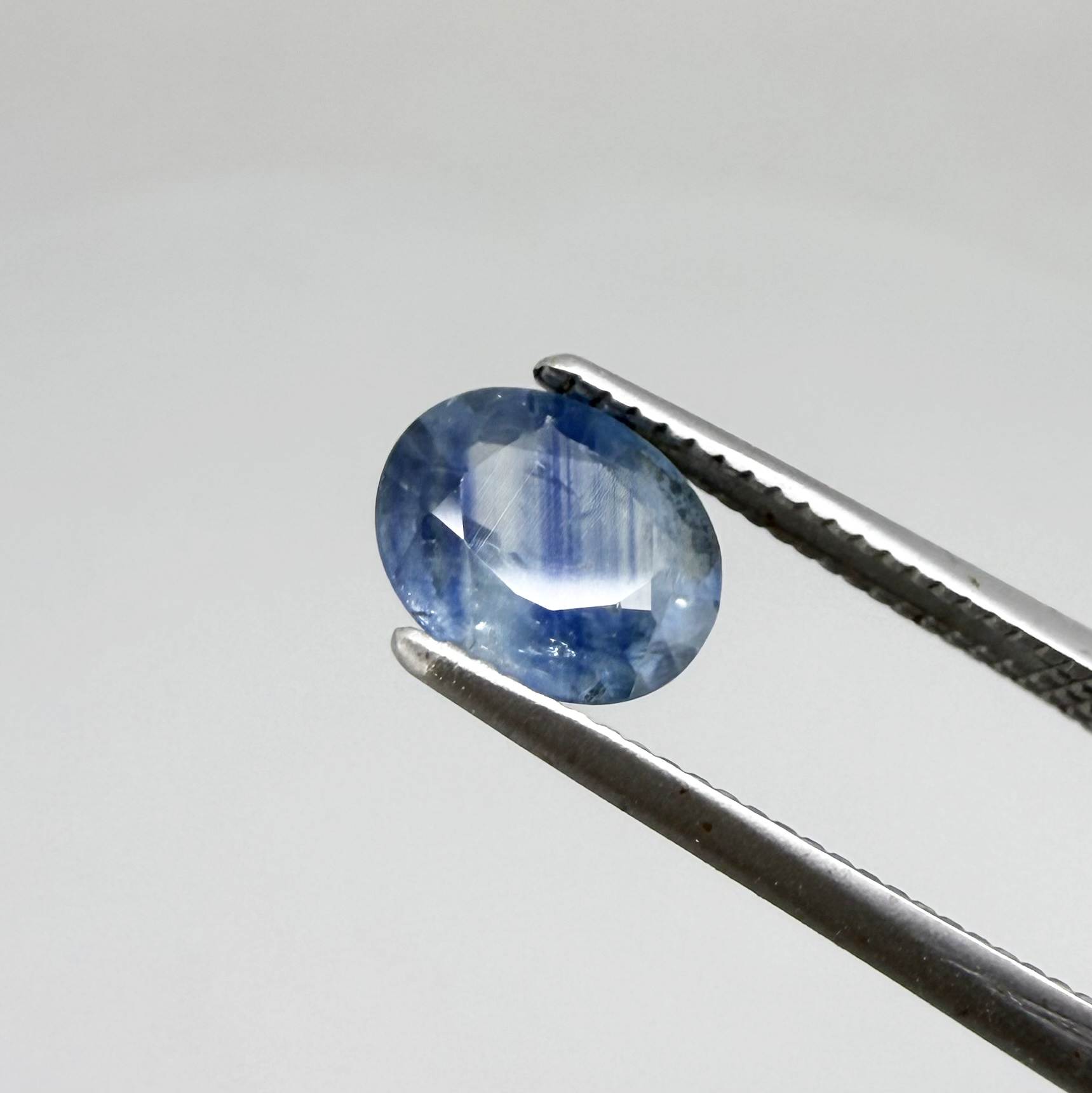 Round light medium blue sapphire from Sri Lanka with natural color zoning and lively brilliance.