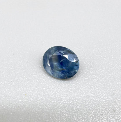 Round light medium blue sapphire from Sri Lanka with natural color zoning and lively brilliance.