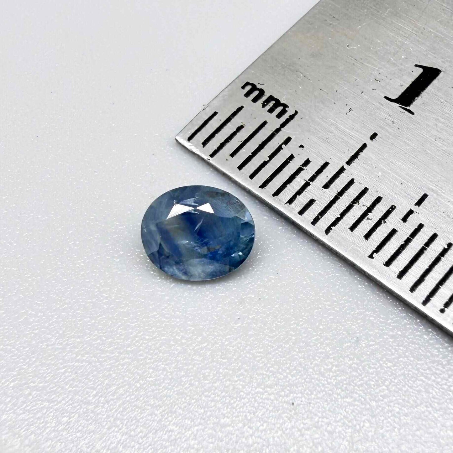 Round light medium blue sapphire from Sri Lanka with natural color zoning and lively brilliance.