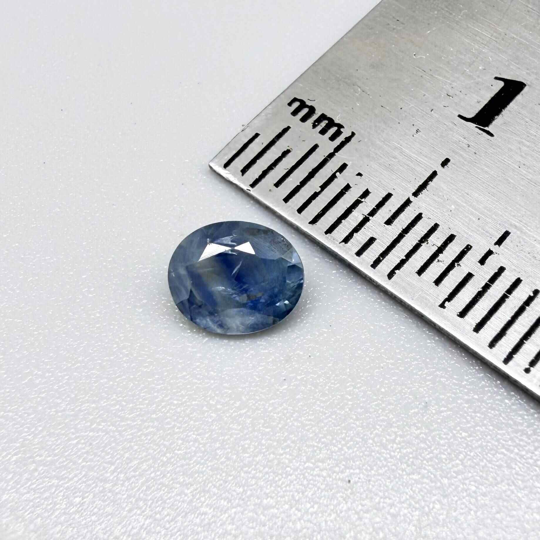 Round light medium blue sapphire from Sri Lanka with natural color zoning and lively brilliance.