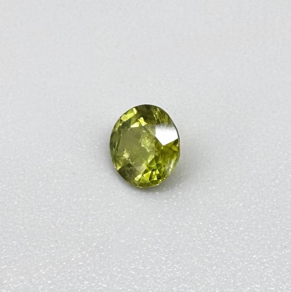 Round yellowish-green sapphire from Bangkaja, Thailand with bright natural color and lively brilliance.