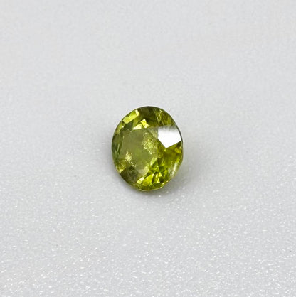 Round yellowish-green sapphire from Bangkaja, Thailand with bright natural color and lively brilliance.