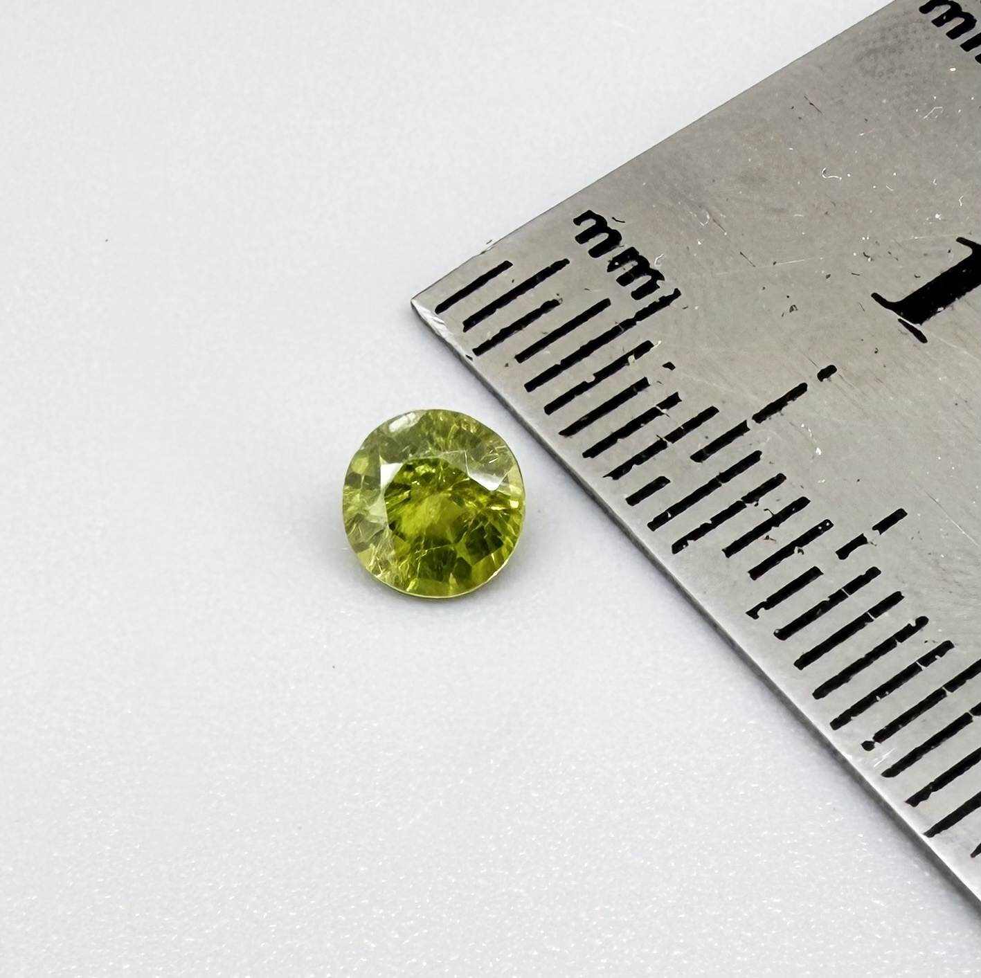 Round yellowish-green sapphire from Bangkaja, Thailand with bright natural color and lively brilliance.