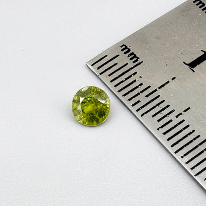 Round yellowish-green sapphire from Bangkaja, Thailand with bright natural color and lively brilliance.
