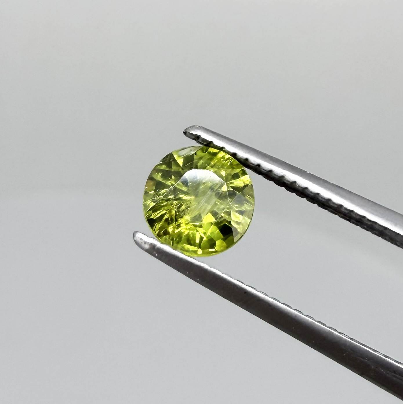 Round yellowish-green sapphire from Bangkaja, Thailand with bright natural color and lively brilliance.