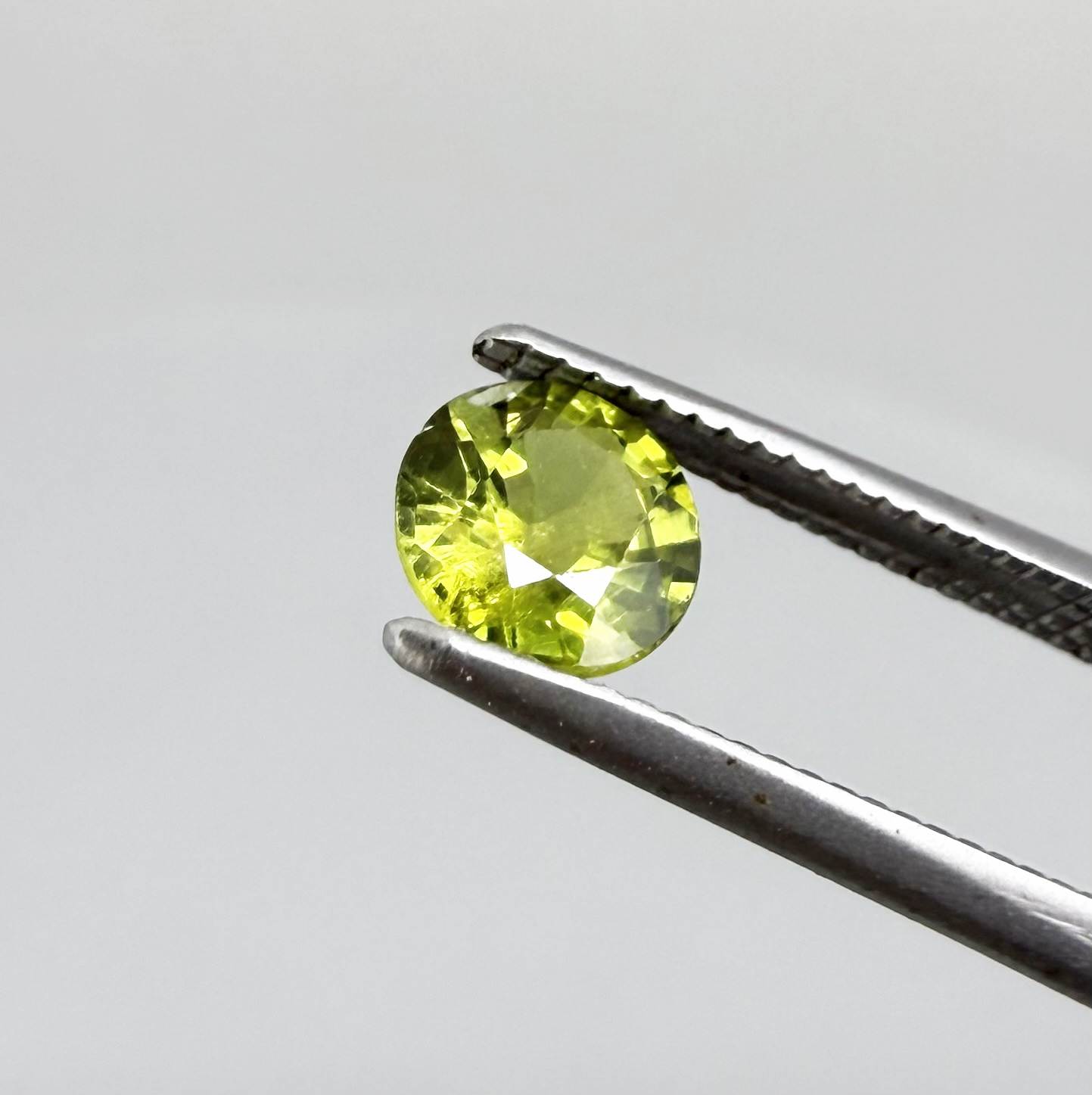 Round yellowish-green sapphire from Bangkaja, Thailand with bright natural color and lively brilliance.