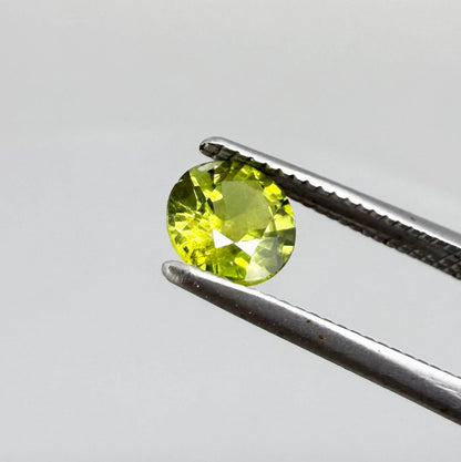 Round yellowish-green sapphire from Bangkaja, Thailand with bright natural color and lively brilliance.