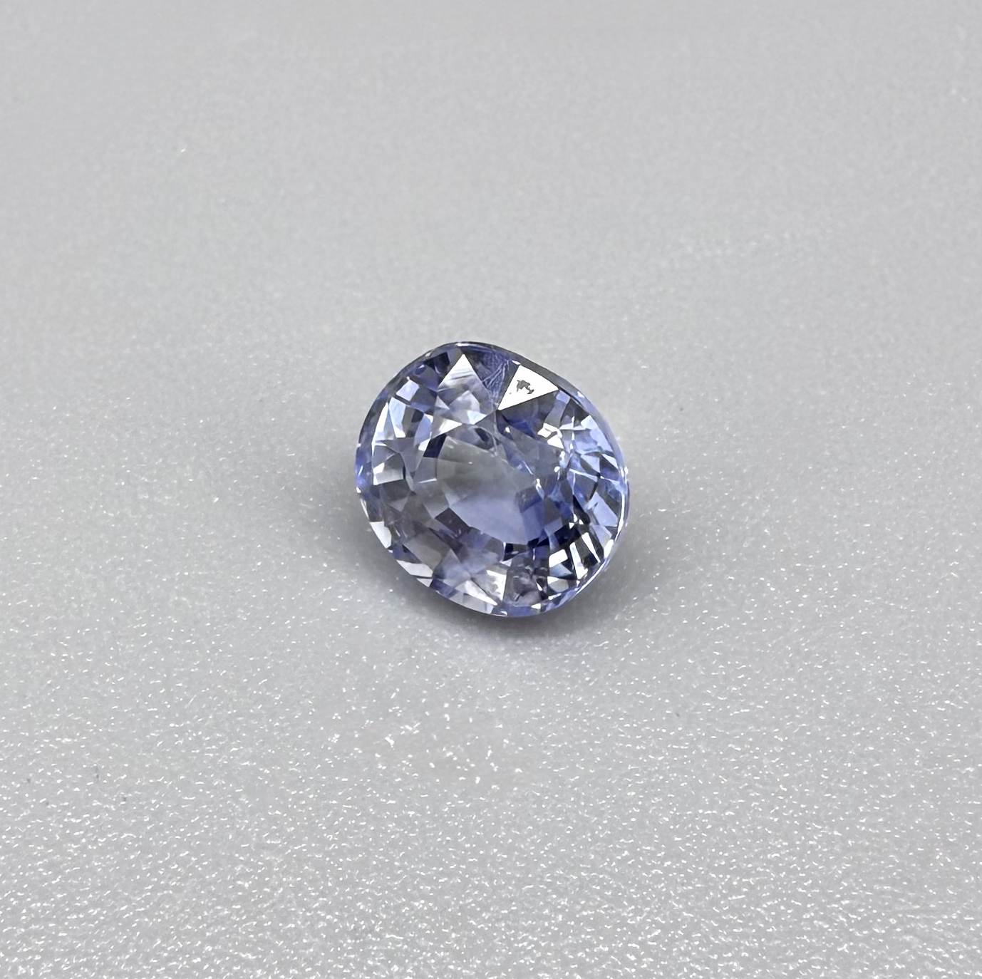 Light cornflower blue sapphire from Sri Lanka in oval cut with bright brilliance and natural transparent crystal structure.