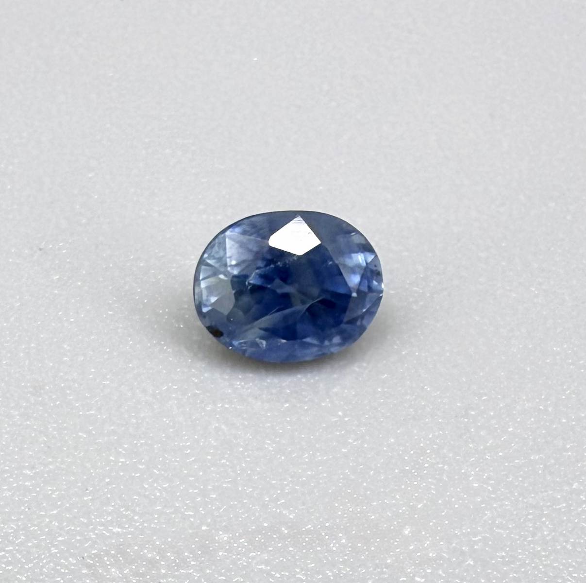 Soft medium blue sapphire in oval cut with natural silky texture and gentle blue color tone.