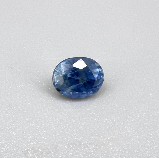 Soft medium blue sapphire in oval cut with natural silky texture and gentle blue color tone.