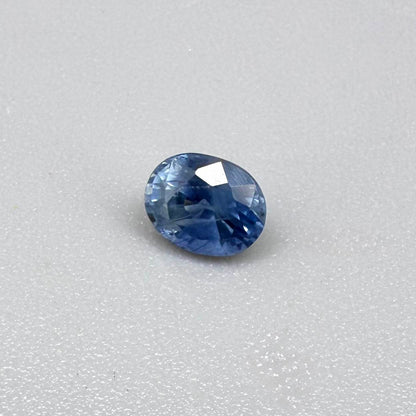 Soft medium blue sapphire in oval cut with natural silky texture and gentle blue color tone.