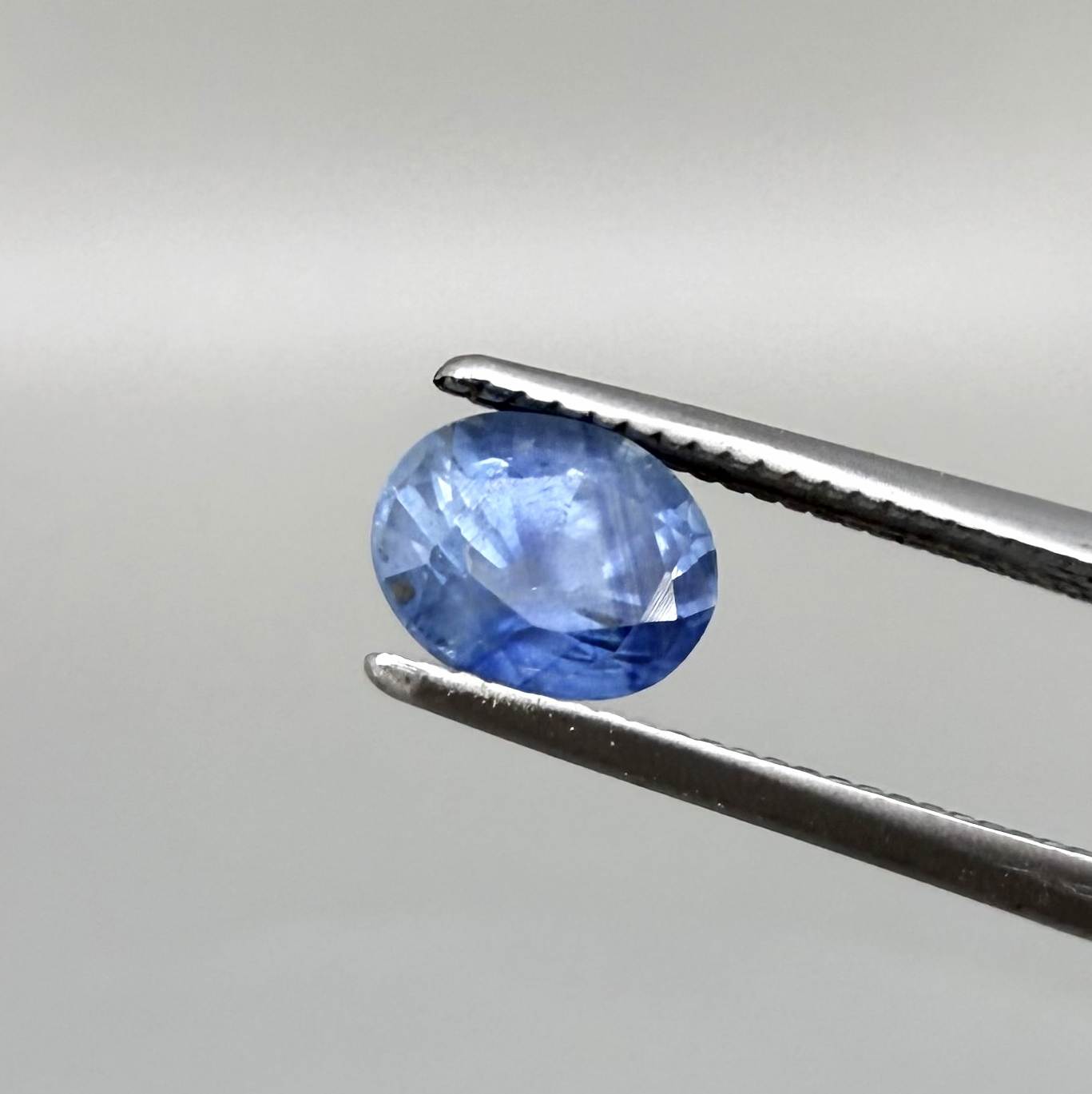 Soft medium blue sapphire in oval cut with natural silky texture and gentle blue color tone.