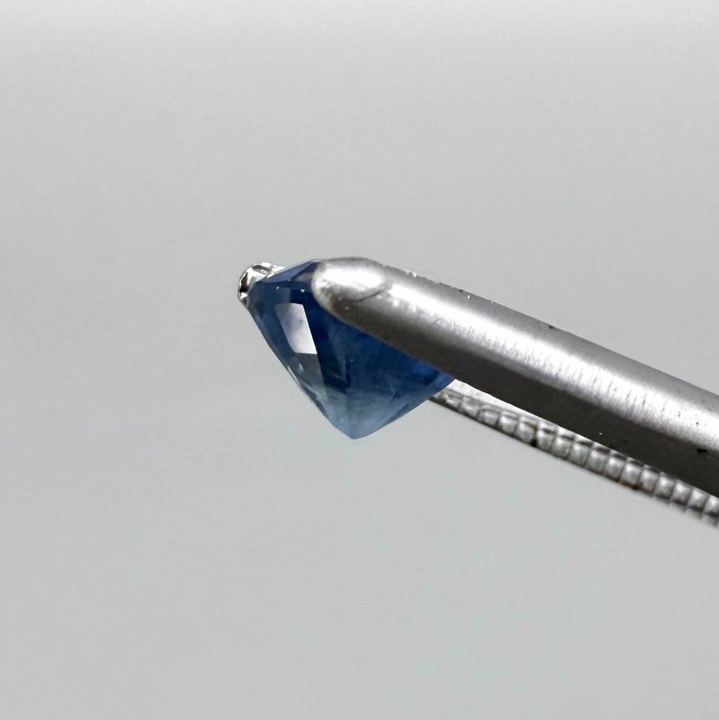Soft medium blue sapphire in oval cut with natural silky texture and gentle blue color tone.