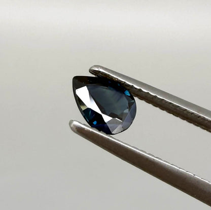 Dark slate blue sapphire from Bangkaja, Thailand in pear cut with deep inky blue tone and natural brilliance.