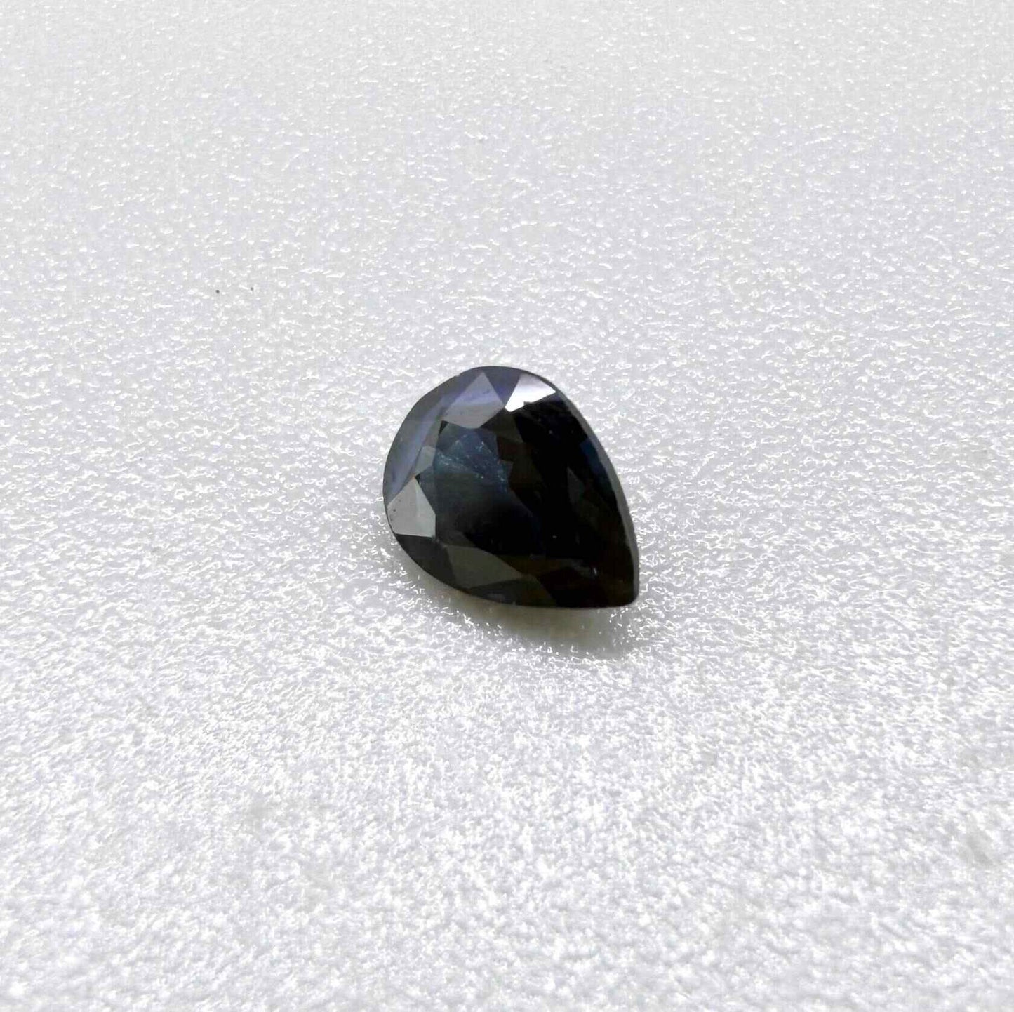 Dark slate blue sapphire from Bangkaja, Thailand in pear cut with deep inky blue tone and natural brilliance.