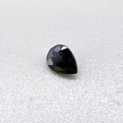 Dark slate blue sapphire from Bangkaja, Thailand in pear cut with deep inky blue tone and natural brilliance.