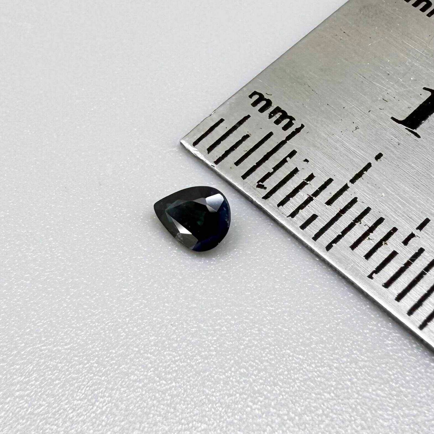 Dark slate blue sapphire from Bangkaja, Thailand in pear cut with deep inky blue tone and natural brilliance.