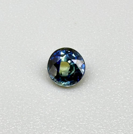 Round-cut bright blue sapphire from Bangkaja, Thailand showing subtle yellow undertone and natural color zoning.