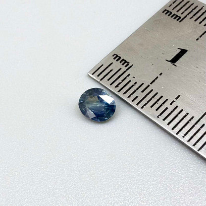 Oval cut light medium blue sapphire from Bangkaja, Thailand with natural color zoning and faceted brilliance.