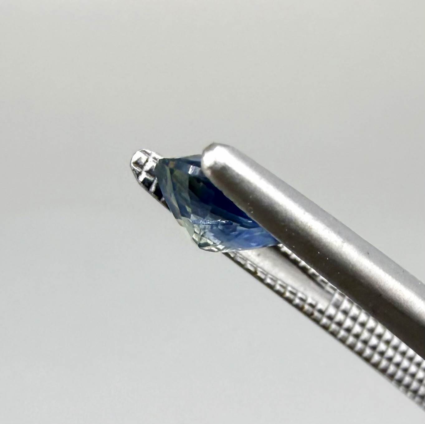 Oval cut light medium blue sapphire from Bangkaja, Thailand with natural color zoning and faceted brilliance.