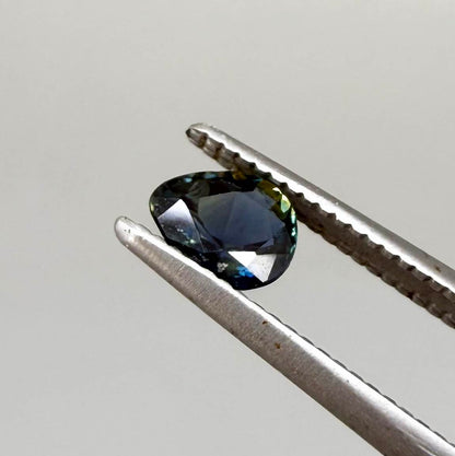 Pear-cut deep teal sapphire from Bangkaja, Thailand with blue-green tones, natural faceted gemstone.