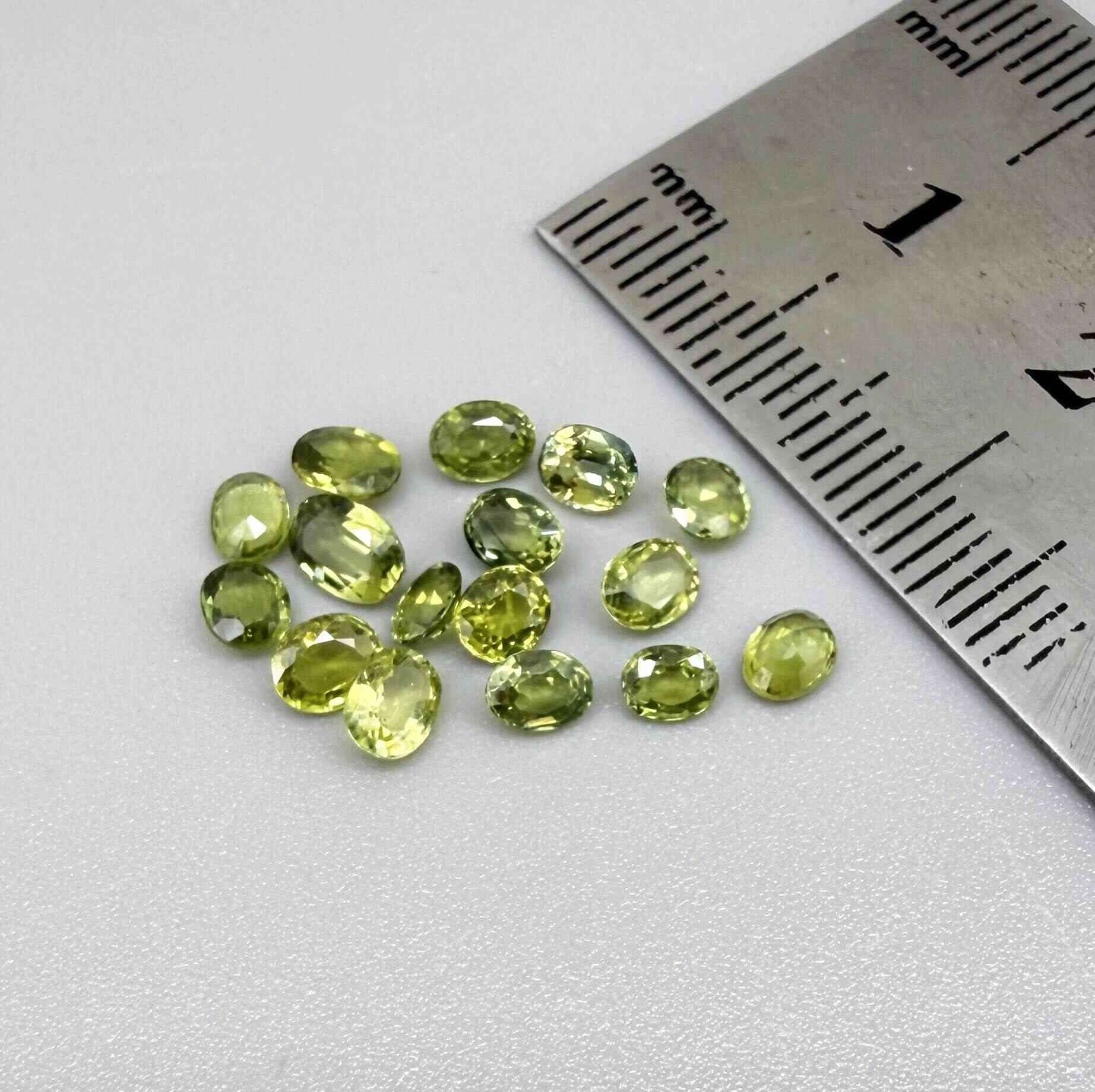 Small parcel of lime green sapphires from Bangkaja, Thailand in oval mixed cuts, natural faceted gemstones.