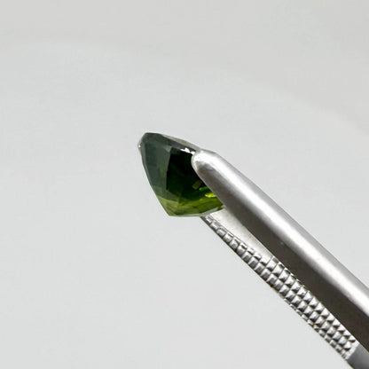 Oval-cut vivid yellowish-green sapphire from Bangkaja, Thailand, natural faceted gemstone with bright lime green tones.