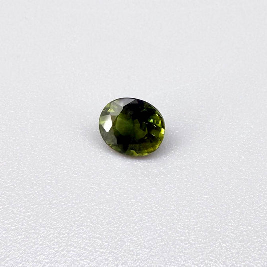 Oval-cut vivid yellowish-green sapphire from Bangkaja, Thailand, natural faceted gemstone with bright lime green tones.