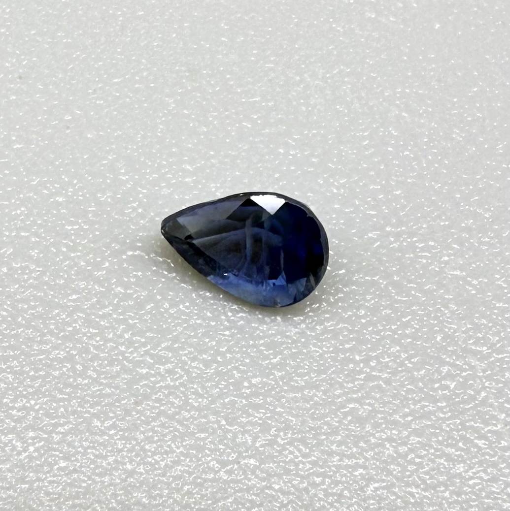Pear-cut royal blue sapphire from Bangkaja, Thailand, natural faceted gemstone with deep blue color.
