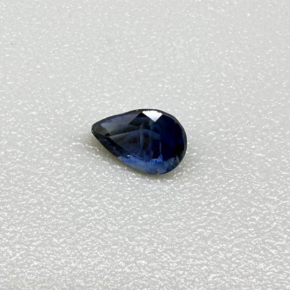 Pear-cut royal blue sapphire from Bangkaja, Thailand, natural faceted gemstone with deep blue color.