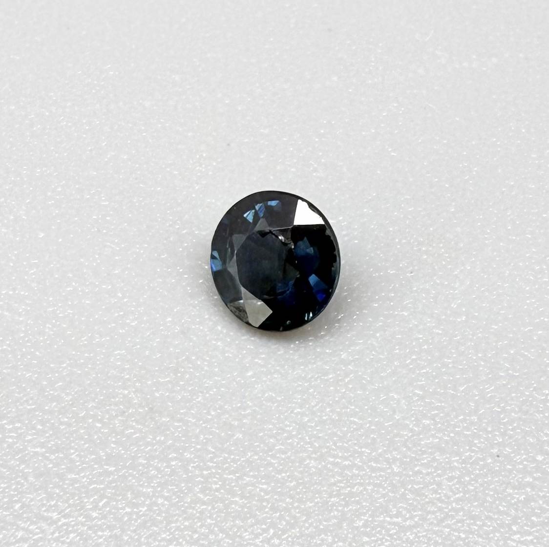 Round-cut vivid deep blue sapphire from Bangkaja, Thailand, natural faceted gemstone.
