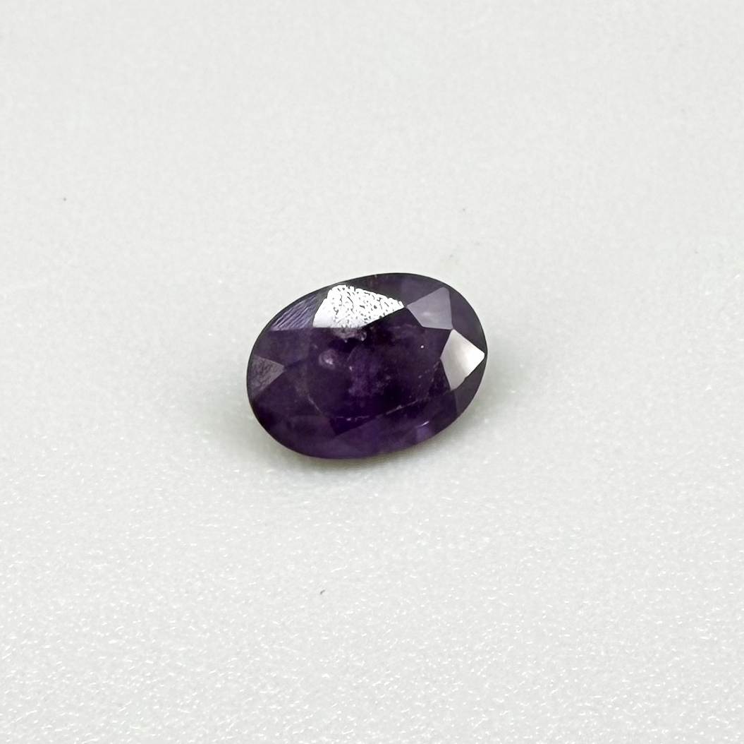 Oval-cut rich purple sapphire from Thailand, natural faceted gemstone suitable for fine jewelry.