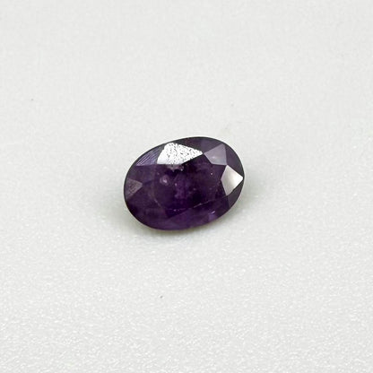 Oval-cut rich purple sapphire from Thailand, natural faceted gemstone suitable for fine jewelry.