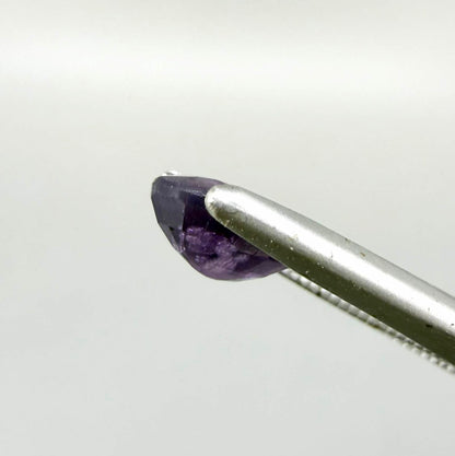 Oval-cut rich purple sapphire from Thailand, natural faceted gemstone suitable for fine jewelry.
