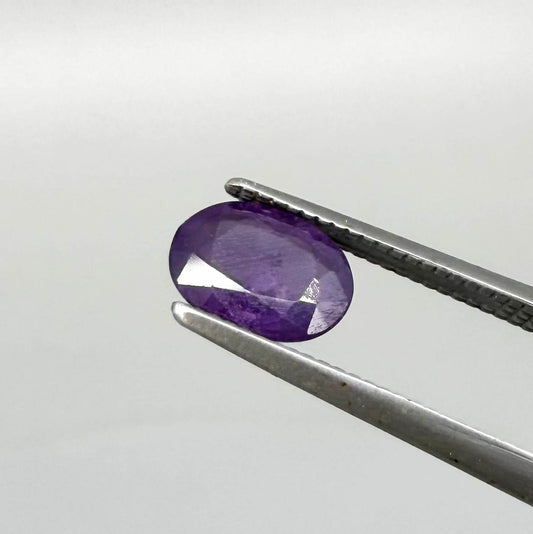 Oval-cut rich purple sapphire from Thailand, natural faceted gemstone suitable for fine jewelry.